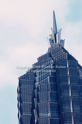 The Jin Mao Tower stands for Shanghai like no other building. It is the second tallest building in Shanghai, dwarfed by the Wold Financial Center, but much prettier. It is one of the few buildings in Shanghai actually worth looking at for its design.
In this image, the tip is captured in the early morning light, revealing endless facets of glistening steel and glass.