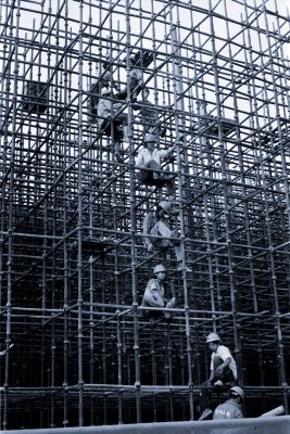 Perched inside a piece of scaffolding for the new maglev construction, workers take a break. Scaffolding like this stretches for hundreds f meters along Changning Road in Shanghai, where the maglev and several new highways and a metro are all being build at the same time. 
With so many lines competing for space, each has to put at its own level to make sure traffic can flow well.