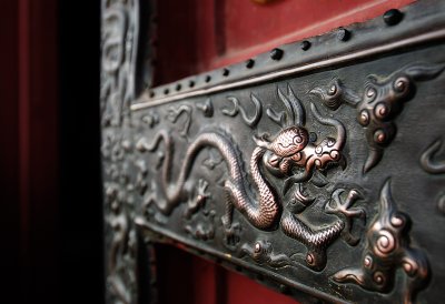 A bronze fitting on one of the door with a hammered dragon is black with patina, except where countless visitors rubbed the dragon's head for good luck.