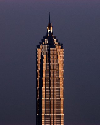 This iconic image of the Jin Mao Tower in Shanghai was taken during the late afternoon, when the sun was lighting it up with a golden glow.

I was high up on the other side of the Huang Pu river and able to isolate the tower against the sky with the sunlight behind me.