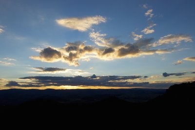 Encircling Sydney almost completely, the Blue Mountains proved a formidable barrier for the early settlers. It was not until they followed some cows who had wandered off and around them that it occurred to them that going around was also an option.
In this image, the sun sets behind the mountains, as seen from Katoomba. 