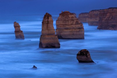 The Twelve Apostles (only eleven remain standing) are situated on one of the harshest stretches of coast known to man. From here on South, nothing but roaring ocean until we hit Antartica. 
This shot was taken before sunrise, blurring the waves.