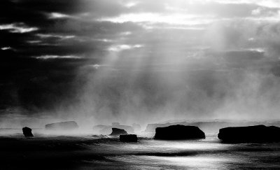 The sun bursts through a cloud covered sky onto the mist covered islets of the bay. At the end of a long day, with only a single shot left on my card, I stopped by the road as the sky cleared enough to let the sun shine through.
Mystically beautiful, the bay is West of the 12 apostles along the Great Ocean Road running from Melbourne to Adelaide.