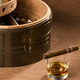 The Double Happiness, with detached case for three cigars, has the build of a tank and the lightness of Okoume wood. The outside is a formidable round shape, the light wraps around it and plays on its features.